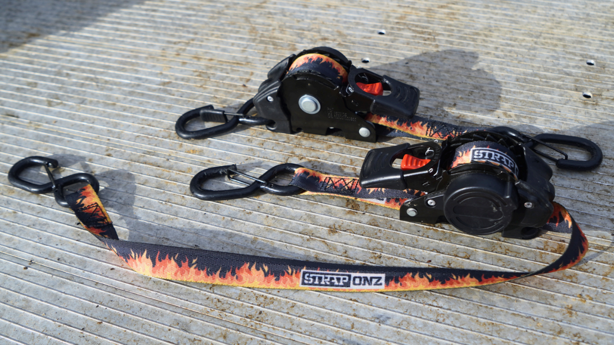 Two Strap Onz Retractable straps wound into their housings on a ute tray