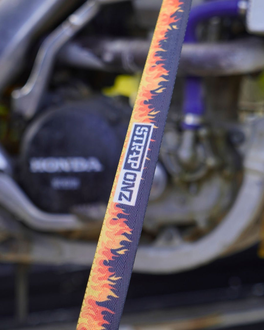 Hand feeding Flames webbing into a Strap Onz ratchet against a ute panel